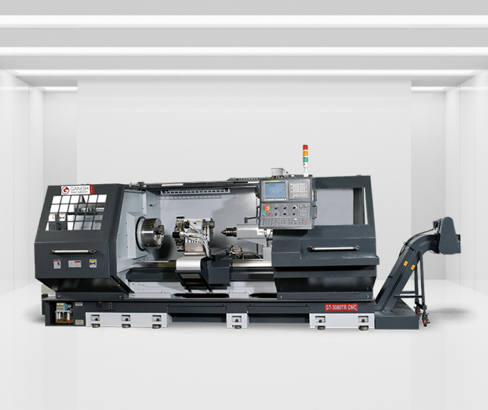 CNC Lathe machine with open middle area against a clean white background room with overhead lights